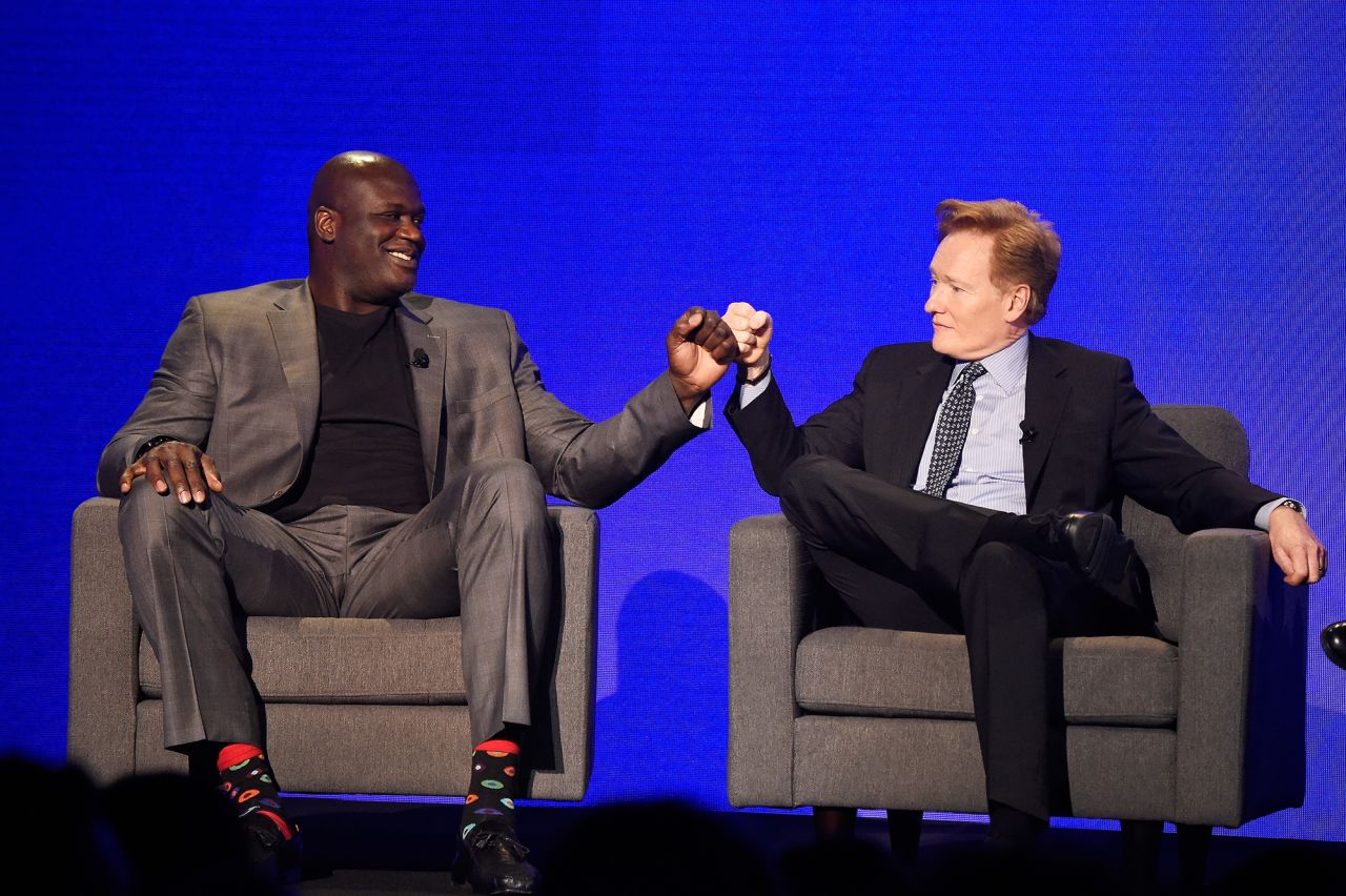 O'Brien fist-bumps basketball legend Shaquille O'Neal during a Turner Upfront show in 2017.