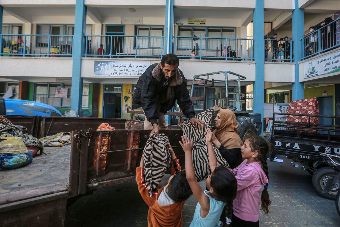 Palestinians unload their belongings at a UN school in Gaza City where they are taking shelter after fleeing their homes in the Shejaiya neighborhood.