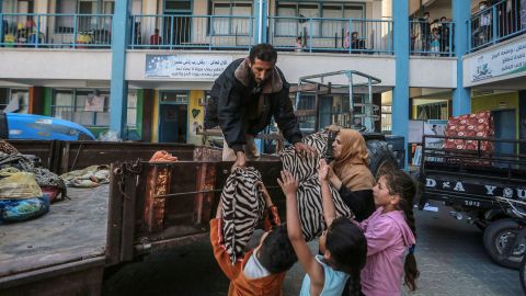 Palestinians unload their belongings at a UN school in Gaza City where they are taking shelter after fleeing their homes in the Shejaiya neighborhood.