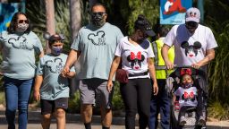 People enter Disneyland Park as it reopens for the first time since the COVID 19 pandemic forced the park to shut down last year on April 30, 2021 in Anaheim, California. 