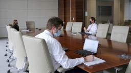 Employees wear protective masks in a conference room at a JLL office in Dallas, Texas, U.S., on Wednesday, Sept. 9, 2020.