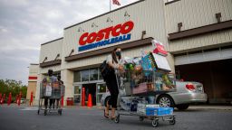 Shoppers wearing face masks leave a Costco wholesale store in Washington, D.C., Aug. 14, 2020. 