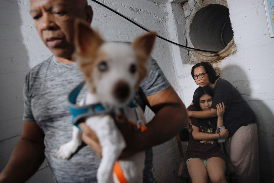 A siren sounds a warning of incoming rockets as people take cover at a shelter in Ramat Gan, Israel, on May 15.