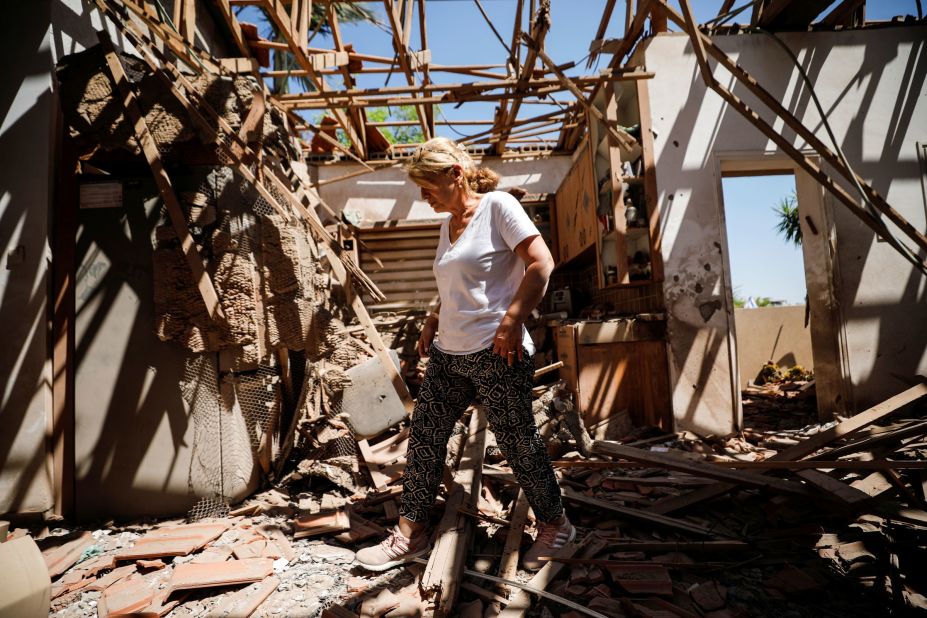 Rachel El-Gazar walks inside her damaged house in Sderot, Israel, following rocket fire from Gaza on May 15.