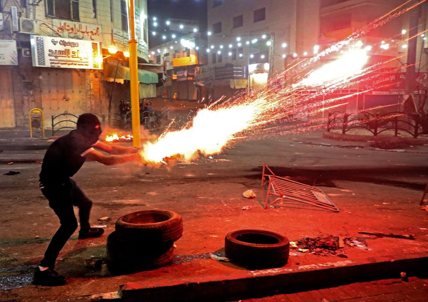 A Palestinian protester launches flares amid clashes with Israeli soldiers in Hebron, West Bank, on May 14.