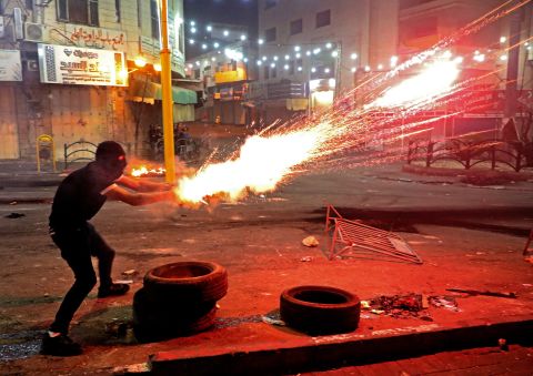 A Palestinian protester launches flares amid clashes with Israeli soldiers in Hebron, West Bank, on May 14.