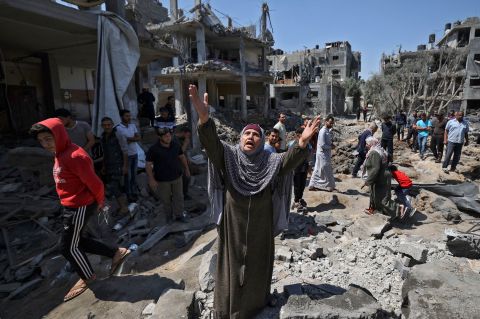 A Palestinian woman reacts amid the damage caused by Israeli airstrikes in Beit Hanoun, Gaza, on May 14.