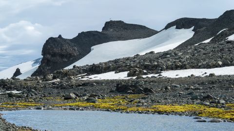 This small lake was formed by melting ice. In the background are the ice sheets on a hill next to Comandante Ferraz Station, on January 5, 2020, in King George Island, Antarctica.