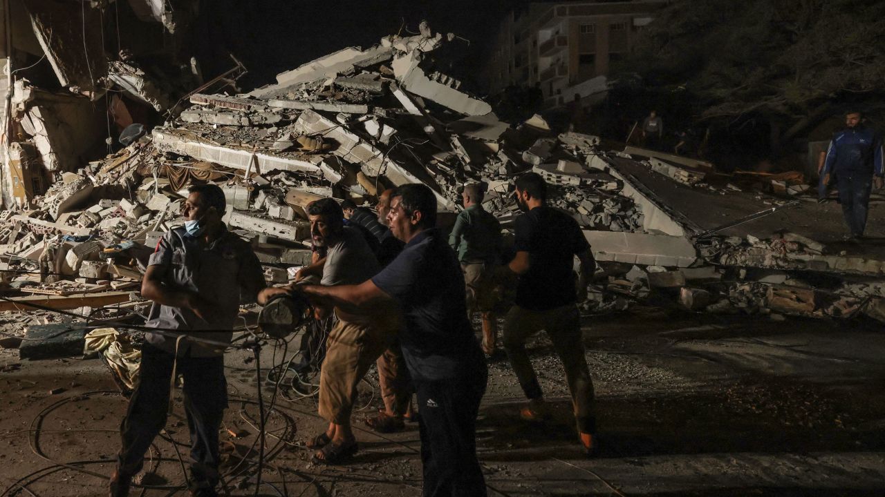 Palestinian firefighters search urgently for survivors and bodies under the rubble after a series of Israeli airstrikes on Gaza on May 16.