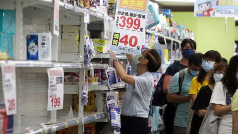 People shop for tissues and toilet rolls at a supermarket in Taipei, Taiwan, on May 15, 2021.