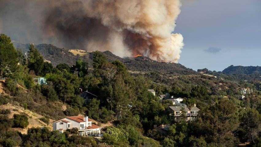 LOS ANGELES, CA - MAY 15, 2021: The Palisades wildfire burns out of control in rugged terrain near homes above Topanga Canyon Boulevard on May 15, 2021 in Los Angeles, California.(Gina Ferazzi / Los Angeles Times via Getty Images)