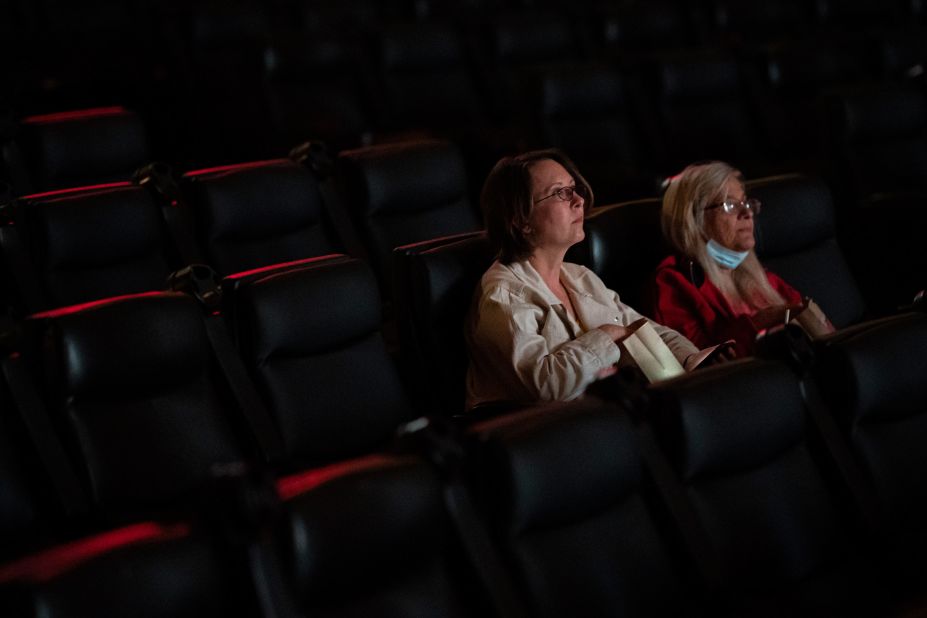 Two moviegoers watch a film at the Kiggins Theatre in Vancouver, Washington, on May 14. Many places in the United States <a href="index.php?page=&url=https%3A%2F%2Fwww.cnn.com%2F2021%2F04%2F30%2Fhealth%2Fus-coronavirus-friday%2Findex.html" target="_blank">are starting to reopen and get back to some sort of normal</a> as more people get vaccinated.