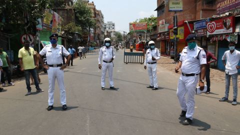 Indian police stand at a checkpoint after West Bengal announced a 15-day lockdown to curb the spread of coronavirus, in Kolkata on May 16, 2021.   