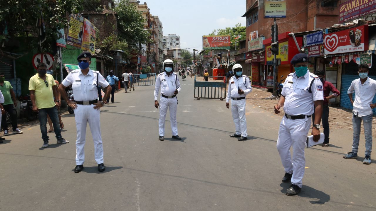 Indian police stand at a checkpoint after West Bengal announced a 15-day lockdown to curb the spread of coronavirus, in Kolkata on May 16, 2021.