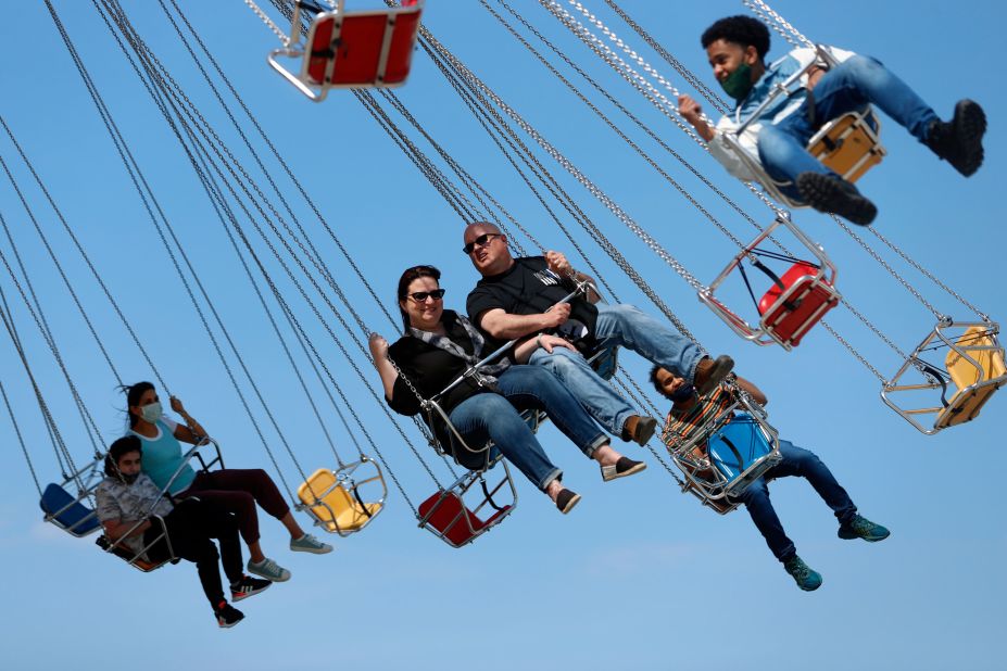 People ride on a wave swinger at Chicago's Navy Pier on May 14. The US Centers for Disease Control and Prevention <a href="index.php?page=&url=https%3A%2F%2Fwww.cnn.com%2F2021%2F05%2F14%2Fhealth%2Fus-coronavirus-friday%2Findex.html" target="_blank">recently revised its Covid-19 guidelines,</a> saying it's safe for fully vaccinated people to remove their face masks in most settings.