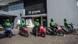 Gojek riders wait for their delivery orders at a distribution centre in Surabaya on May 17, 2021, as Gojek and Tokopedia unveiled a merger to form GoTo Group, creating the largest tech firm in the world's fourth most populous country. (Photo by Juni Kriswanto/AFP/Getty Images)