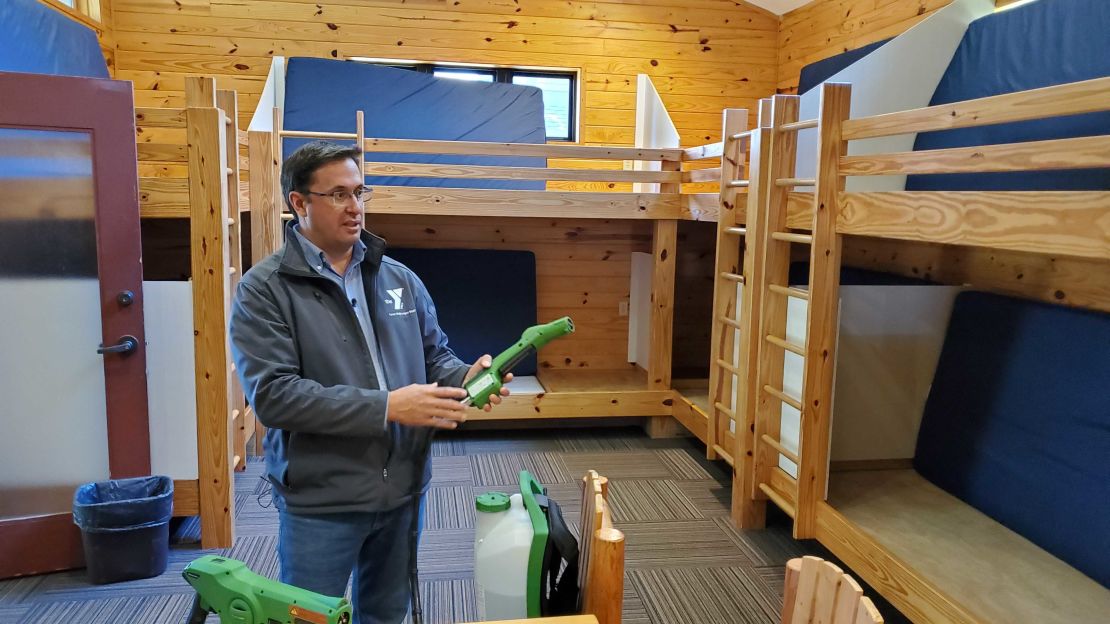 Jeff Merhige shows the cleaning protocols for the cabins, where bunks now have sneeze guards. 