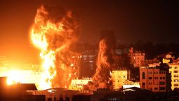 Fire and smoke rise above buildings in Gaza City as Israeli warplanes target the Palestinian enclave, early on May 17.