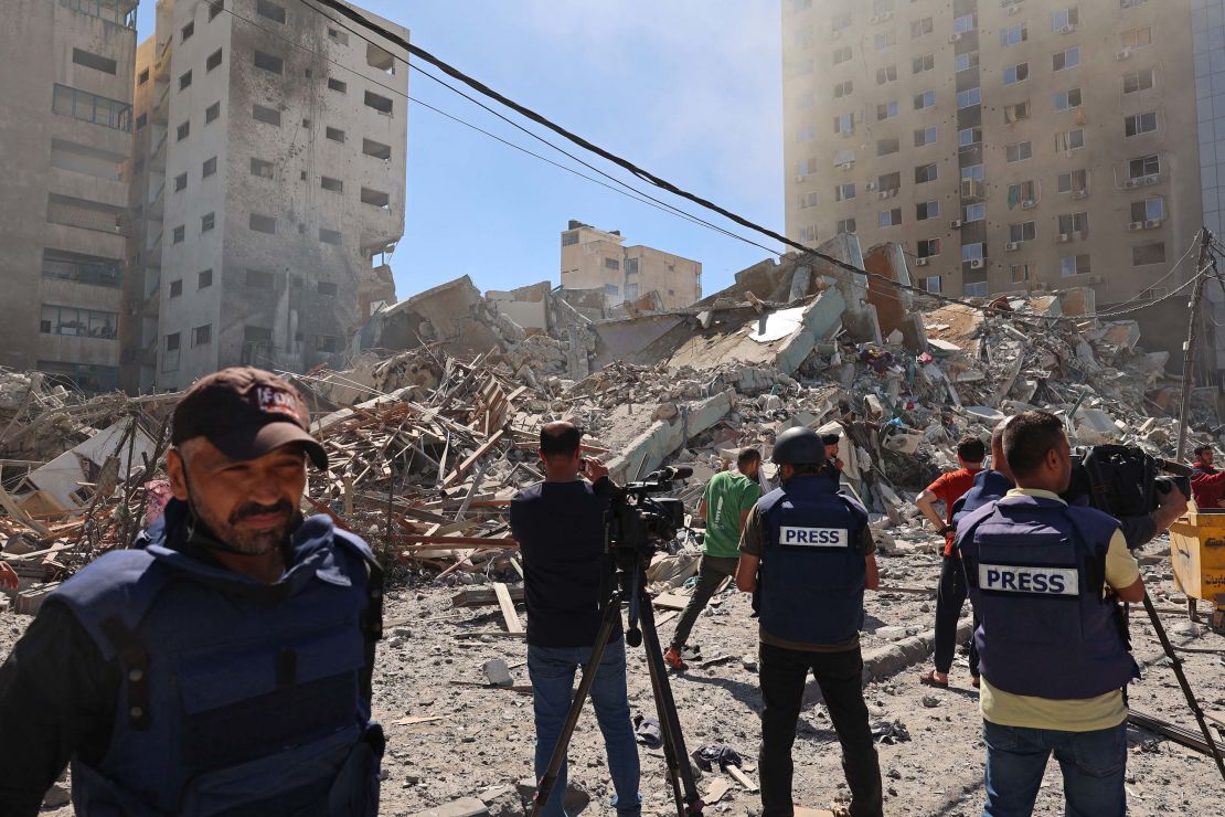 Journalists work near the destroyed Al-Jala'a building, which housed international press offices, following an Israeli airstrike in Gaza on Saturday, May 15.