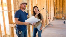 Joanna Gaines visiting husband Chip to check in on the progression of the Pahmiyer home, as seen on Fixer Upper. Joanna points out where is she wanting to put a fireplace.