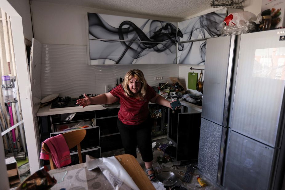 A woman reacts inside her kitchen on May 17 after a rocket from Gaza hit her apartment building in Ashdod, Israel.