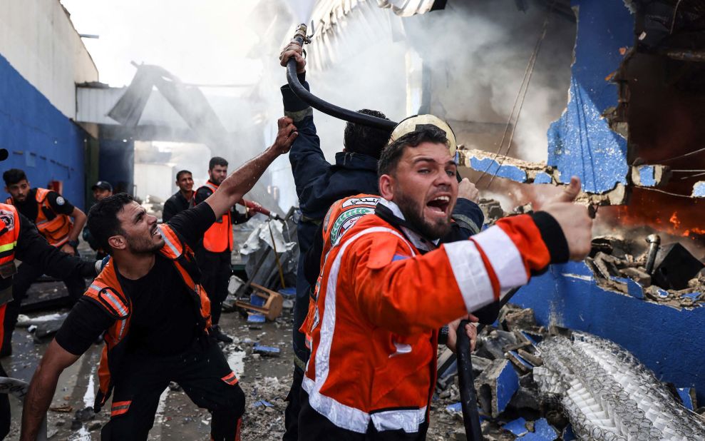 Palestinian firefighters douse a fire at the Foamco mattress factory after an Israeli airstrike east of Jabalia, Gaza, on Monday, May 17.