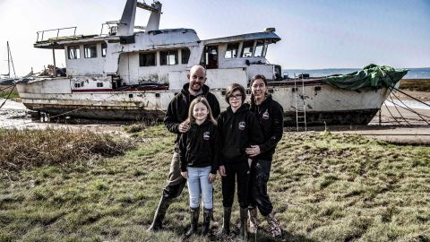 Simon and Gemma Robins with children Emilia and Mason and the ship they bought on eBay.