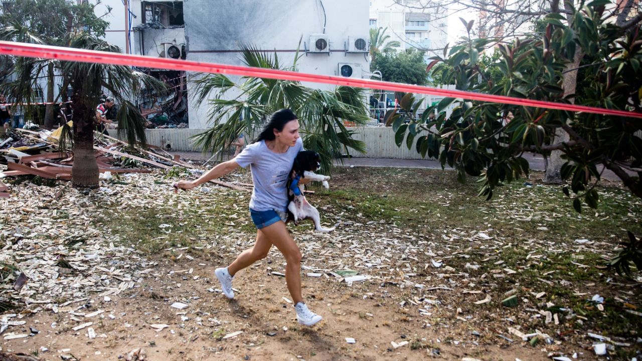 A woman runs for a shelter in Ashdod, Israel, after sirens warned of rockets fired from Gaza on Monday.