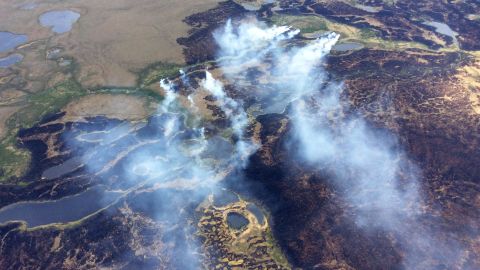 Smoke rises from a fire in Alaska's Yukon Delta National Wildlife Refuge in 2015. A new study finds that wildfires in boreal forests and peatlands of the Arctic can sometimes spawn "zombie fires," which can burn all the way through winter.