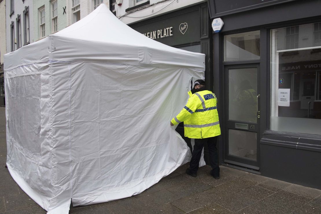 An officer is seen outside the Clean Plate cafe on Southgate Street on May 11 in Gloucester, as police search for remains of the missing girl Mary Bastholm.
