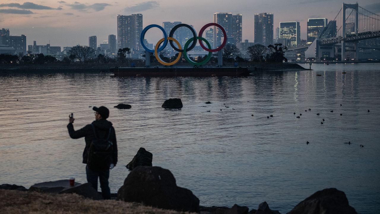 A man takes a photograph near the Olympic Rings on January 22, 2021 in Tokyo, Japan.