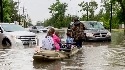 Parents use boats to pick up students from schools after nearly a foot of rain fell in Lake Charles in Louisiana.