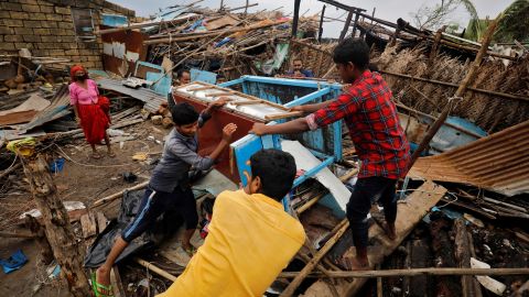 People salvage their belongings from a damaged house after cyclone Tauktae hit in the western state of Gujarat, India.
