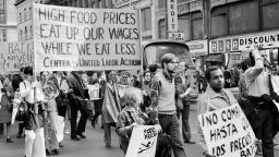 People carry signs during a demonstration against high food prices in New York in the 1970s.