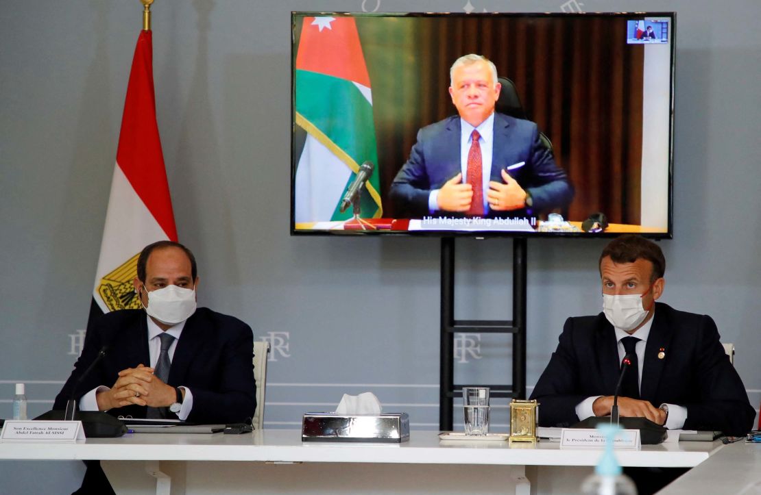 Egyptian President Abdel Fattah el-Sisi, left, and French President Emanuel Macron attend a video conference with Jordan's King Abdullah II ibn Al Hussein, on screen, to work on a ceasefire proposal at the Elysee Palace in Paris, on May 18.