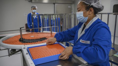Workers sort vials of the Sinovac Covid-19 vaccine. 