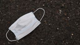 MERRICK, NEW YORK - MARCH 31:  A used mask lies outside of Pat's Farms grocery store on March 31, 2020 in Merrick, New York. Since the coronavirus pandemic people have been discarding used masks on the ground rather than dispensing them in the trash. The World Health Organization declared coronavirus (COVID-19) a global pandemic on March 11.  (Photo by Al Bello/Getty Images)