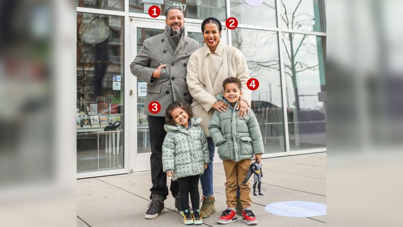 Keewa Nurullah (No. 2) stands with her husband, Doug Freitag (No. 1), and their two kids Noni (No. 3), age 3 and Faraz (No. 4), age 5, outside Kido, their family-owned children's apparel, book and toy store on Chicago's South Side, in January 2021.