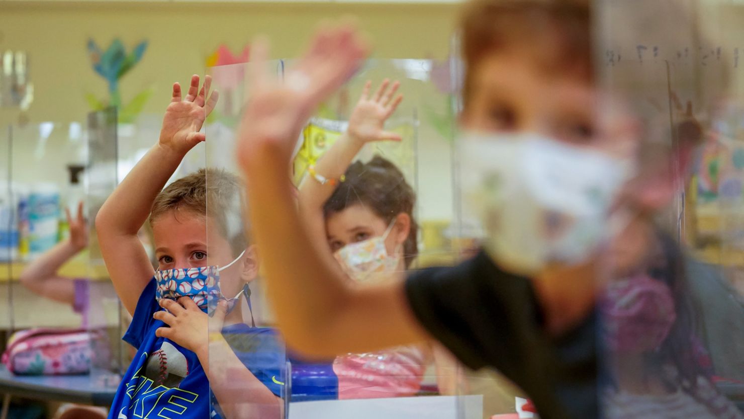 Kindergarten students wearing masks and separated by plexiglass at Milton Elementary School in Rye, New York, on Tuesday, May 18.