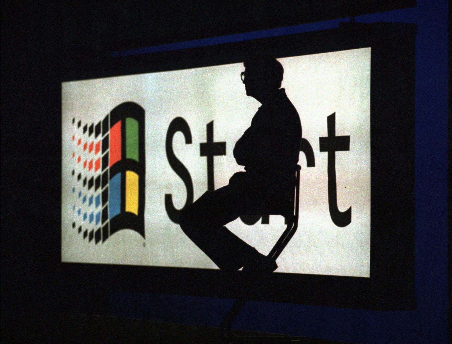 Gates sits on a stage in Redmond, Washington, during a launch event for the Windows 95 operating system. Microsoft, with its MS-DOS system and later the Windows platform, was the first company to dominate the personal computer market.