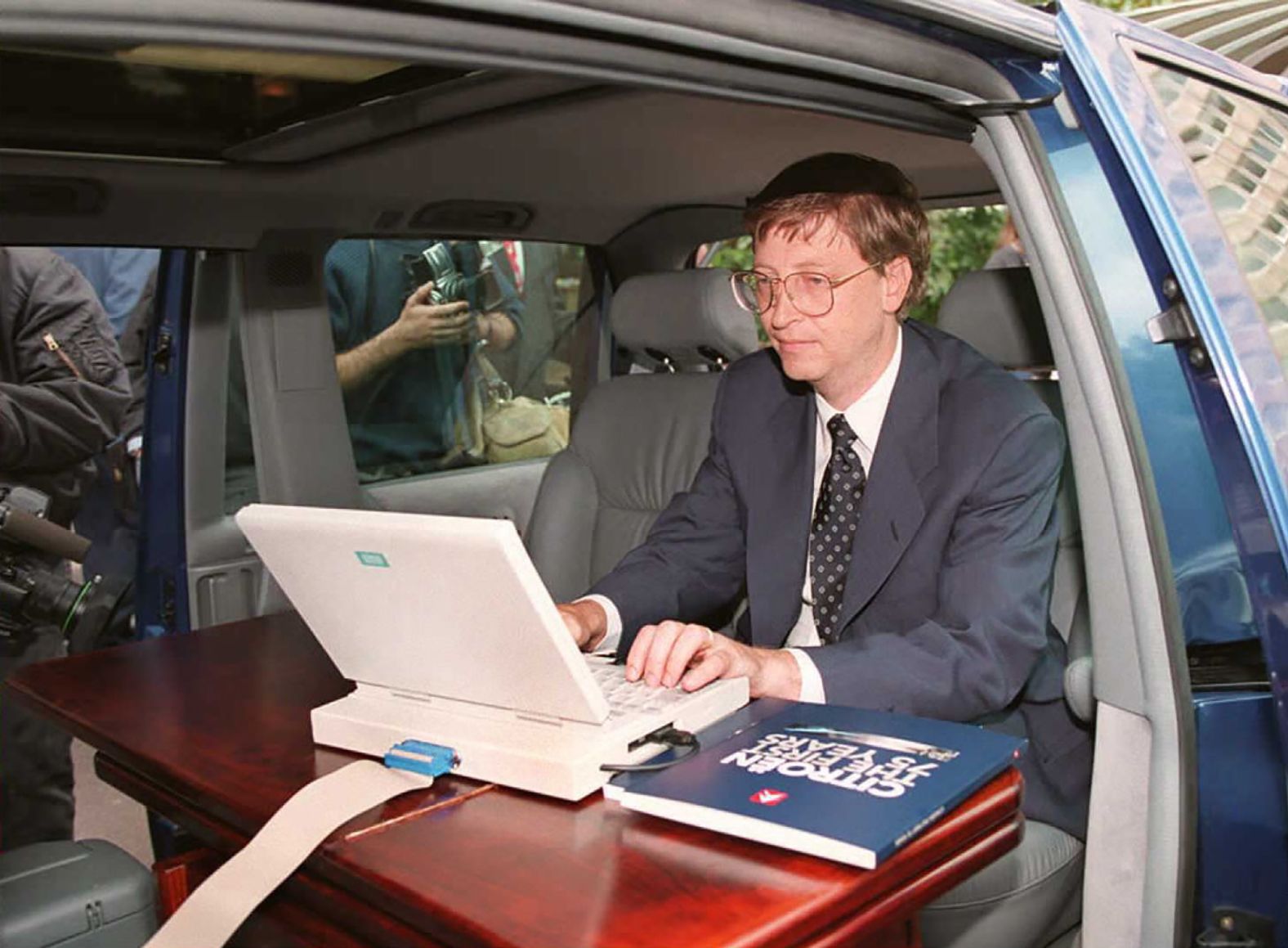 Gates demonstrates Windows 95 from his vehicle before a news conference in Paris in September 1994.