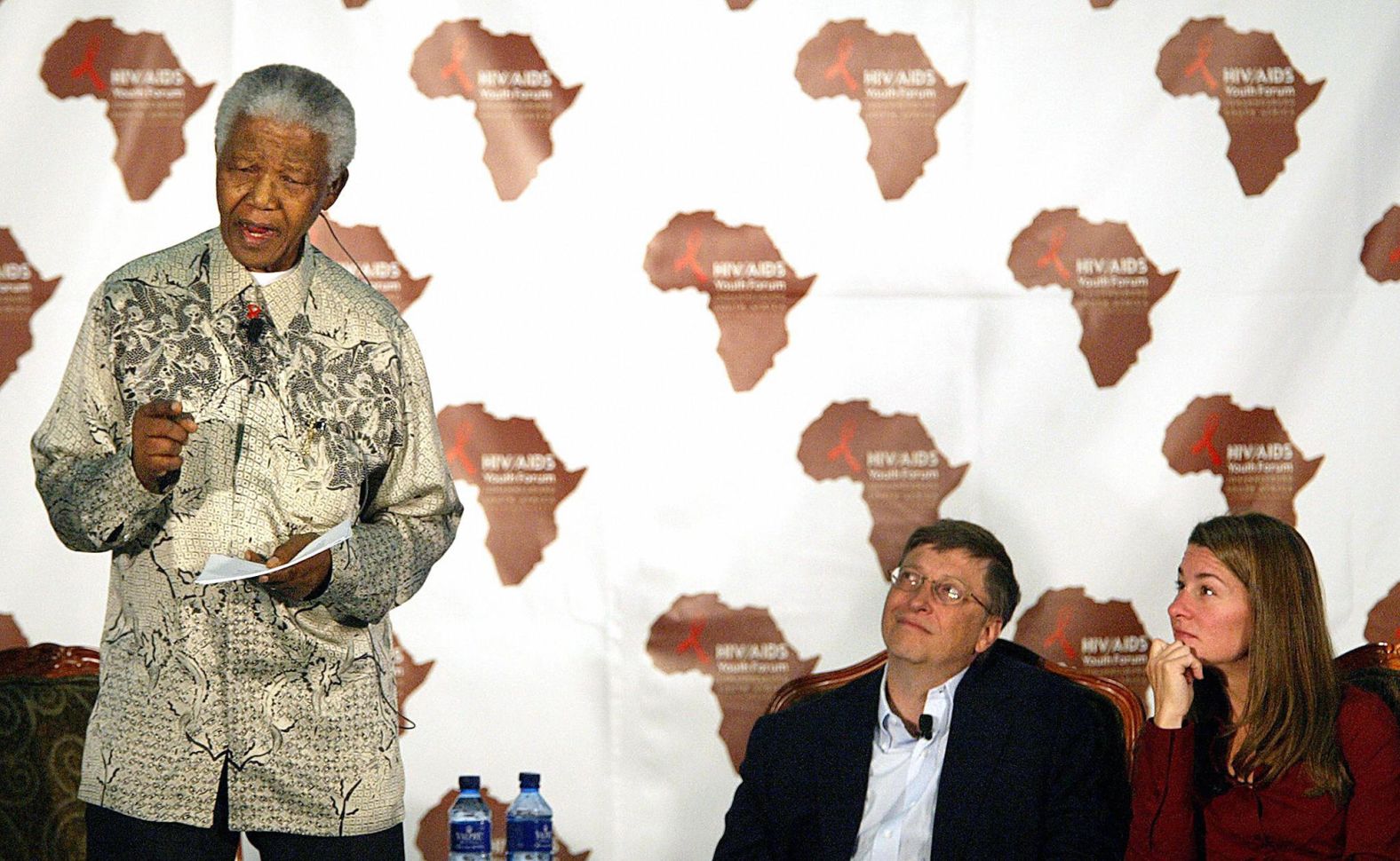The Gateses listen to former South African President Nelson Mandela in Johannesburg as he addresses a youth forum on HIV/AIDS in 2003.