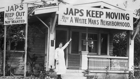 B.G. Miller points to an anti-Japanese sign on her house in Hollywood, California, in 1923.