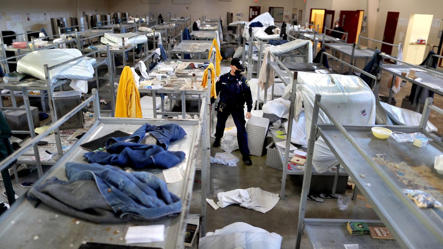 Bristol County Sheriff's Department Corrections officer Marie Garcia, an 18-year veteran, walks through rows of bunk beds in disarray in Dartmouth, Massachusetts, on May 2, 2020.