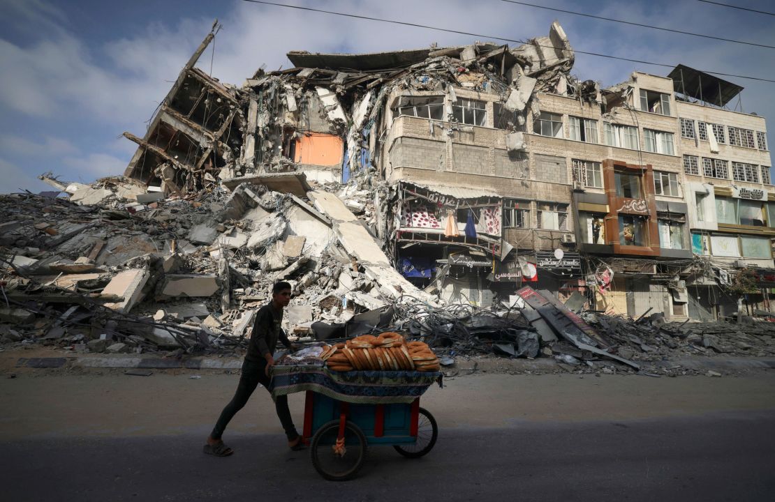 A Palestinian man walks past the destroyed Al-Shuruq building in Gaza City on Thursday.