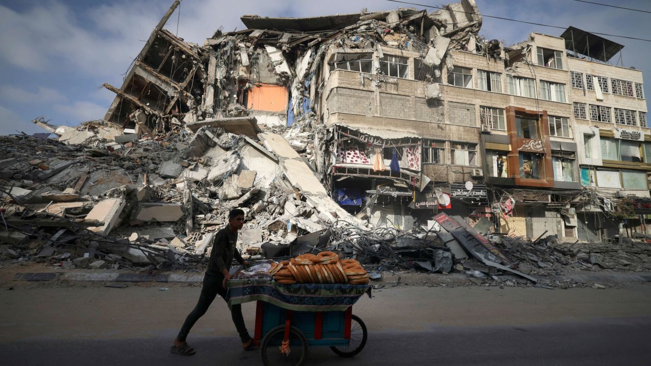 A Palestinian man walks past the destroyed Al-Shuruq building in Gaza City on Thursday.