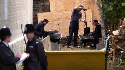 Police sift through soil as they search for clues in the Fred West murder cases in the garden of 25 Midland Road, Gloucester, on April 27, 1994.