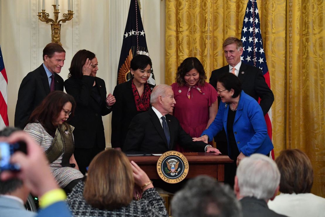 President Joe Biden hands over a pen to Hawaii's Democratic Senator Mazie Hirono after signing the Covid-19 Hate Crimes Act in the East Room of the White House in Washington, DC on May 20, 2021.