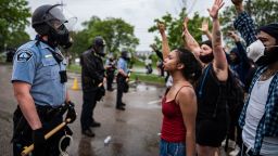 Protesters and police face each other during a rally for George Floyd in Minneapolis on Tuesday, May 26, 2020. Four Minneapolis officers involved in the arrest of the black man who died in police custody were fired Tuesday, hours after a bystander's video showed an officer kneeling on the handcuffed man's neck, even after he pleaded that he could not breathe and stopped moving. (Richard Tsong-Taatarii/Star Tribune via AP)