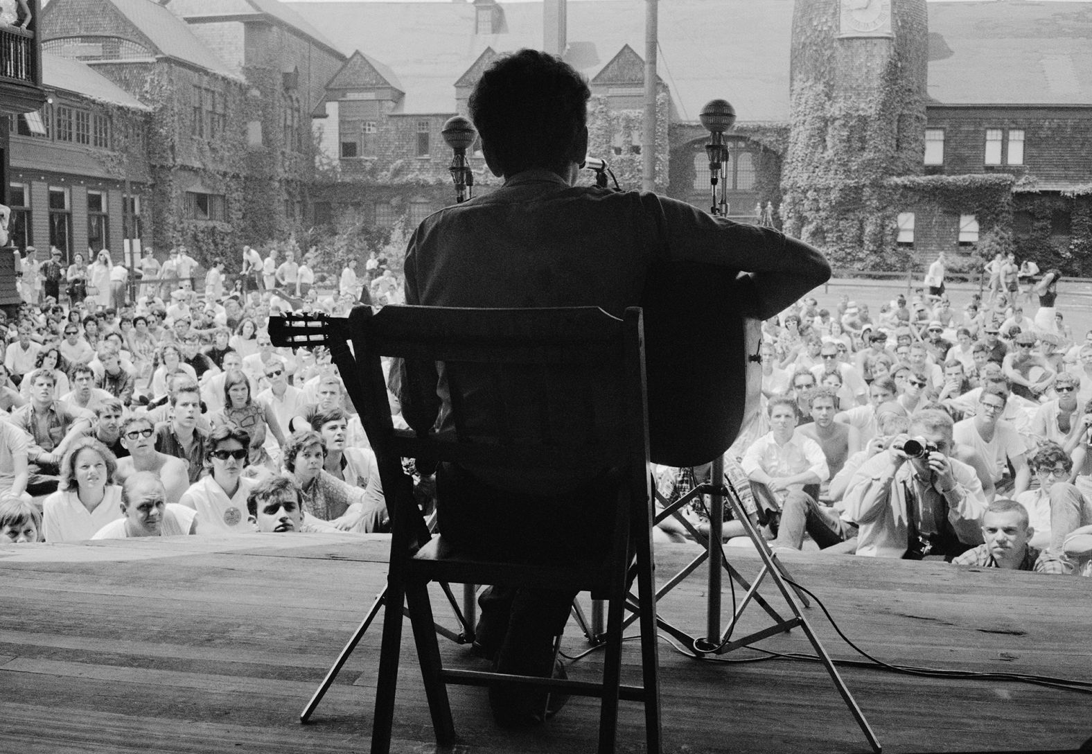 Dylan plays the guitar at the Newport Folk Festival in Newport, Rhode Island, in 1963. Dylan was known in his early career for playing the guitar and the harmonica, and for his distinctive vocal phrasing. 